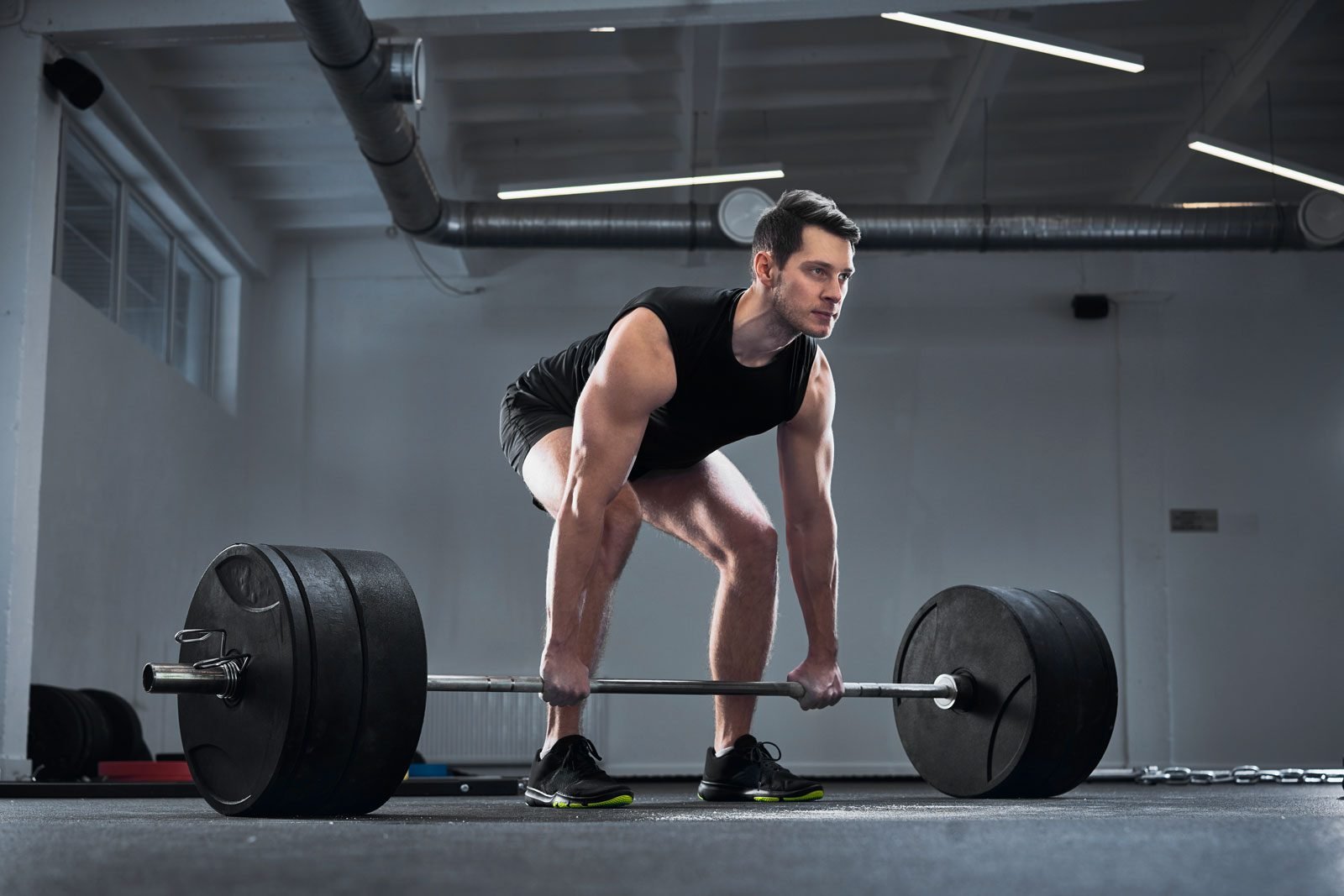 man-doing-barbell-exercise-at-gym-during-weight-YTHEXN2-e1700148435926.jpg